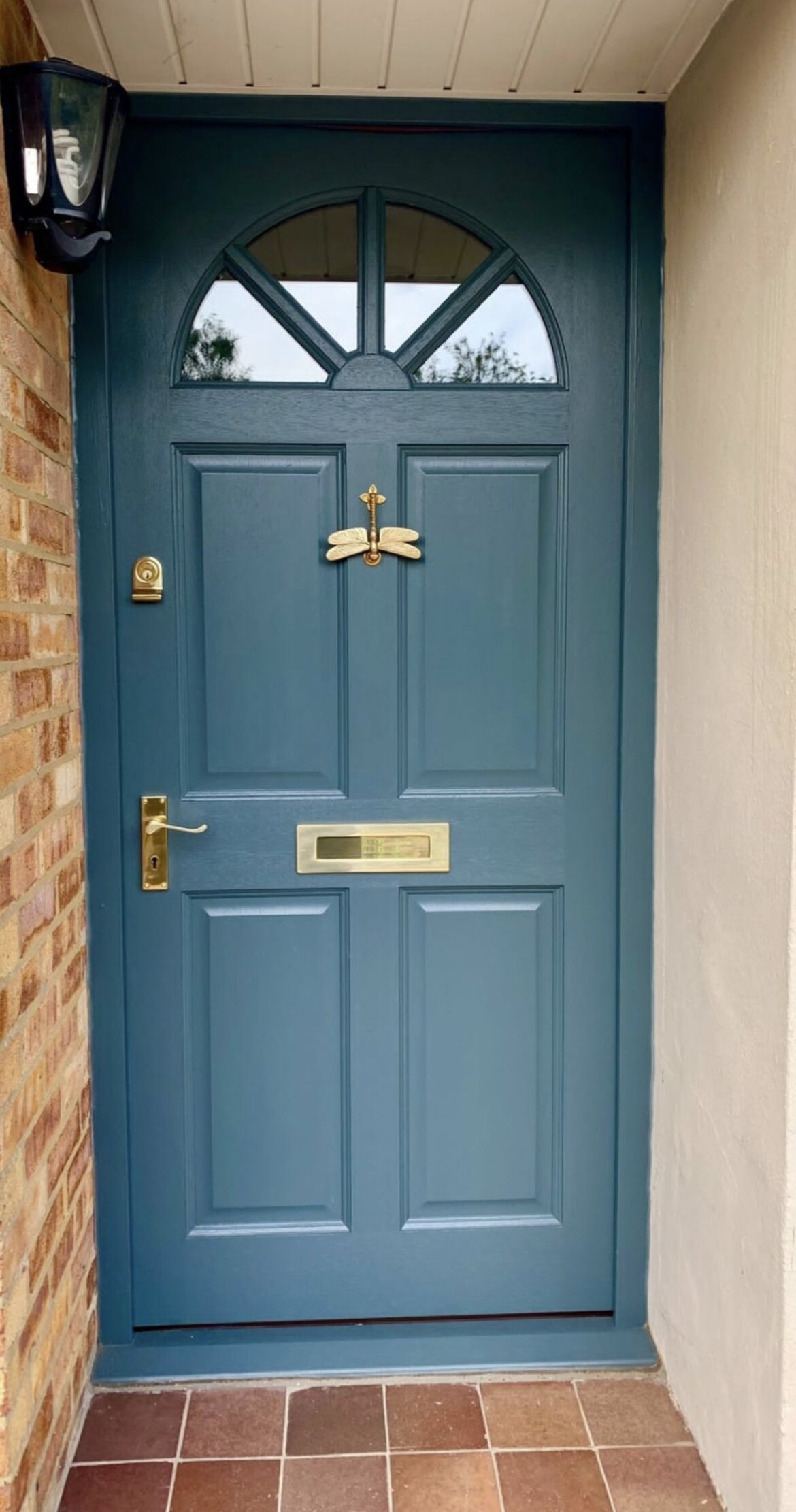 Blue painted hardwood entrance door with brass door furniture